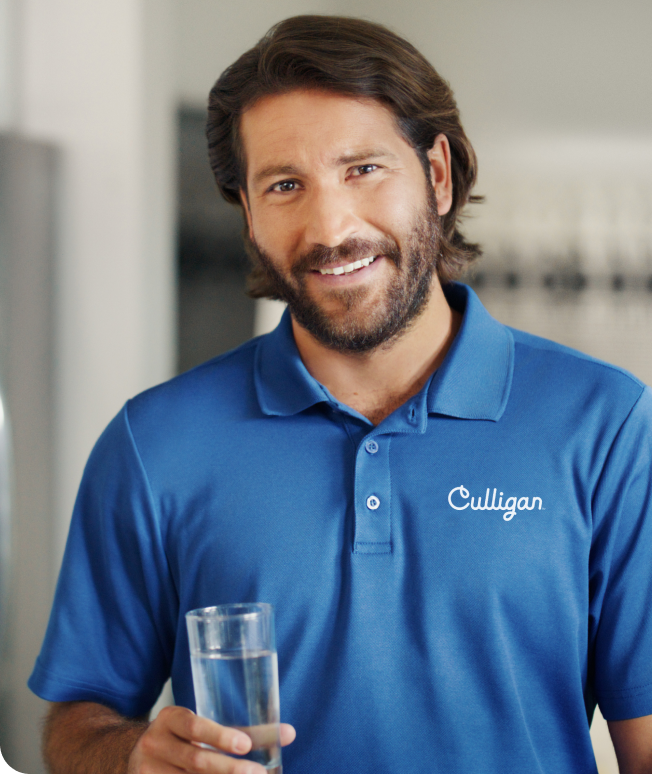 Man using culligan t-shirt with a glass of water