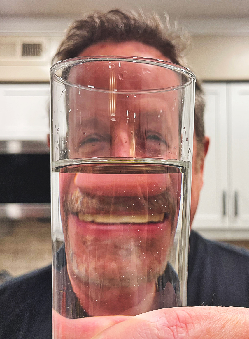 man raising a glass of water