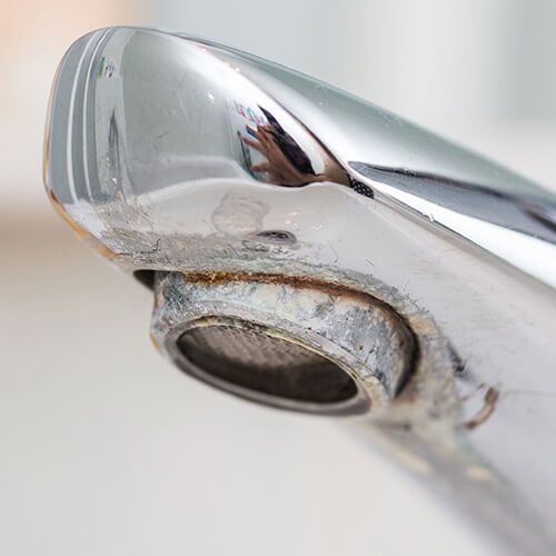 hard water buildup on a faucet
